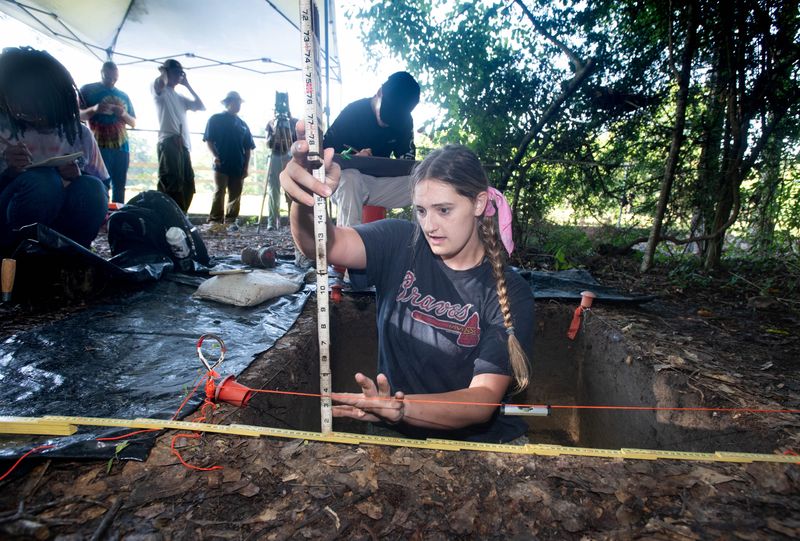 Cayla Scholfield takes a measurement as she and fellow University of West Florida archaeology students excavate at the Mission San Joseph de Escambe site in Molino on June 20, 2025.