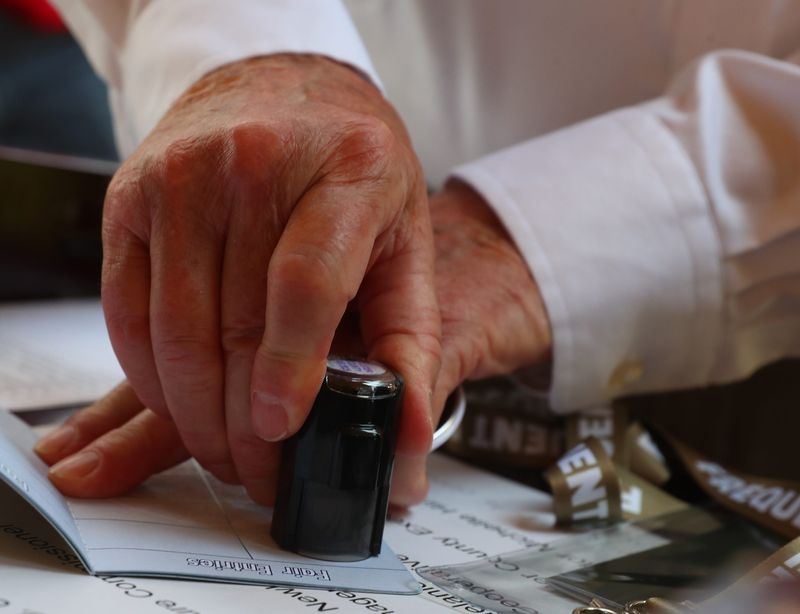 New York State commissioner of agriculture and markets, Richard Ball stamps a frequent fairgoer passport for New York State senator Michelle Hinchey during a press event at the Ulster County Fairgrounds on June 23, 2025. The event was held to highlight $2 million in state funding to promote county fairs across the state.