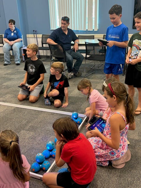 Kids prepare for a robot soccer game in a recent summer program at Fruitville Library.