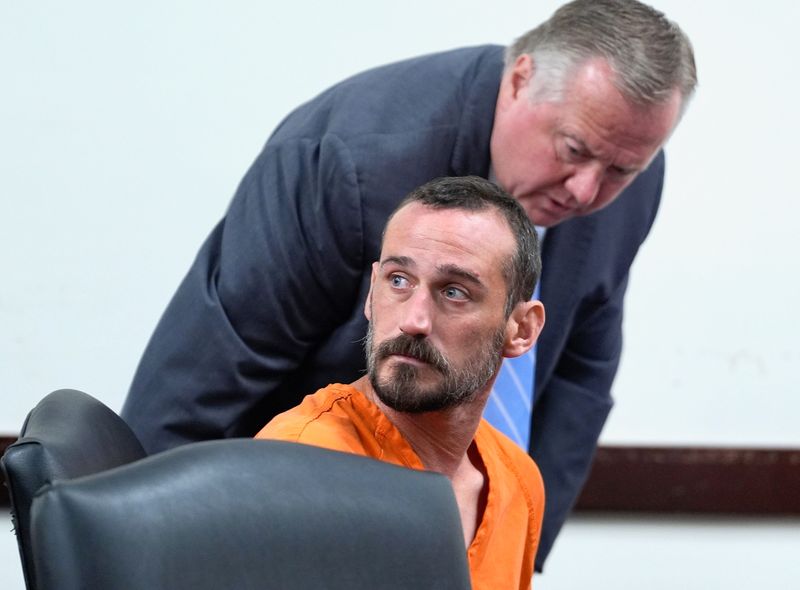 Scott Gardner turns as his lawyer speaks to him at the S. James Foxman Justice Center in Daytona Beach on Tuesday, June 24, 2025. Gardner is accused of leaving his 18-month-old son to die in a hot truck while he went for a haircut and drank at an Ormond-by-the-Sea bar last week.