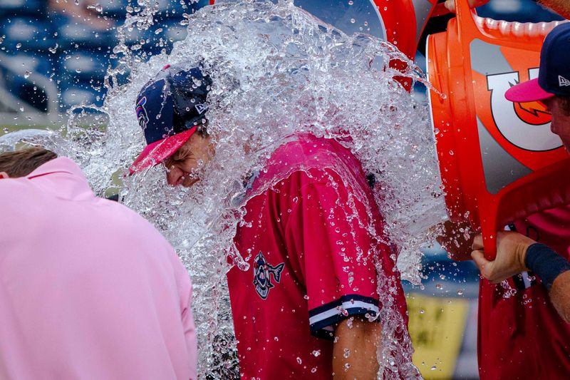 The Blue Wahoos' Cody Morissette gets doused by teammates following the team's win on June 22.