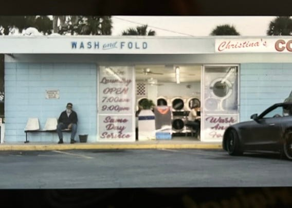 A screenshot from the haptic trailer for "F1: The Movie" with Brad Pitt shows Christina's Coin Laundry in New Smyrna Beach.