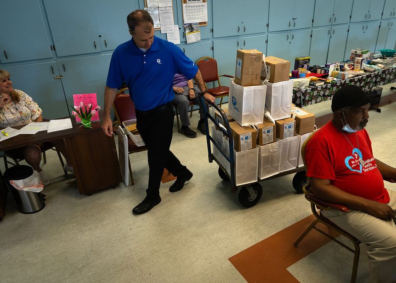 Florida Power & Light Company and Bay County Council on Aging volunteers distribute hurricane preparedness meal kits to seniors in Panama City, Fla., June 25, 2025. Each kit includes three days of shelf-stable, nutritious food, water and snacks for seniors who may not be able to leave their homes or receive home-delivered meals after a storm. (Tyler Orsburn/News Herald)