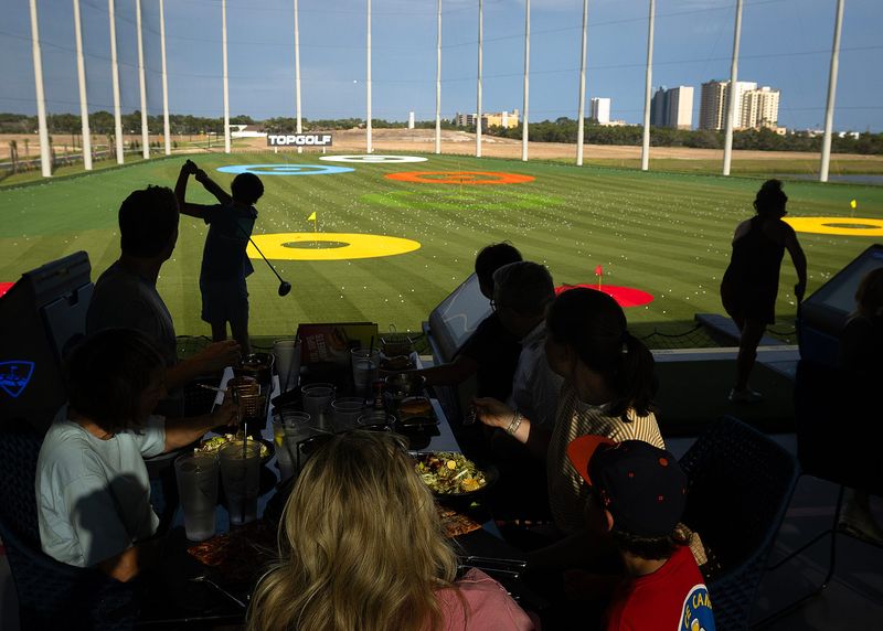 People are seen at Topgolf in Panama City Beach on June 26 for the sports entertainment complex’s ribbon cutting and grand opening preview. Topgolf opens to the public June 27.