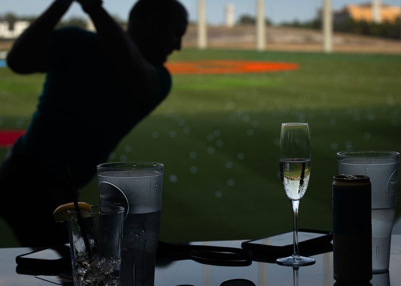 People are seen at TopGolf in Panama City Beach, Fla., June 26, 2025. The event was the sports entertainment complex’s ribbon cutting and grand opening preview night. (Tyler Orsburn/News Herald)