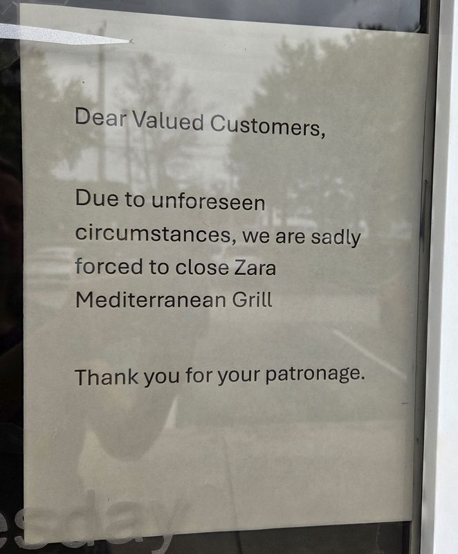 A sign posted on both of Zara's entry doors.