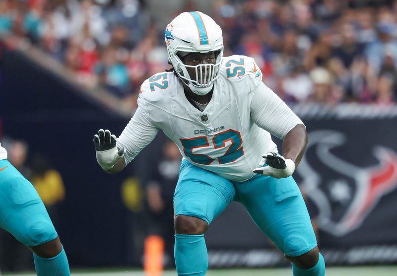 Dec 15, 2024; Houston, Texas, USA; Miami Dolphins offensive tackle Patrick Paul (52) in action during the game against the Houston Texans at NRG Stadium. Mandatory Credit: Troy Taormina-Imagn Images