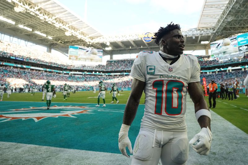 Dec 8, 2024; Miami Gardens, Florida, USA; Miami Dolphins wide receiver Tyreek Hill (10) celebrates after defeating the New York Jets during overtime at Hard Rock Stadium. Mandatory Credit: Jasen Vinlove-Imagn Images