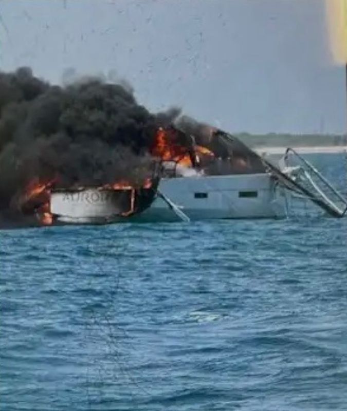 Four people were rescued from this burning boat June 28 about a mile off the coast of Cape Canaveral.