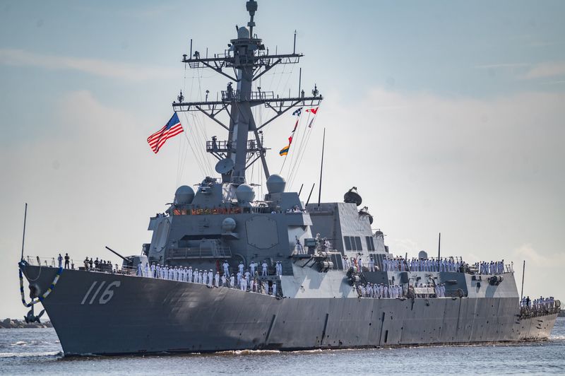 Crew members of The USS Thomas Hudner (DDG 116) line the deck of the destroyer class ship as it returns to Naval Station Mayport after a six-month deployment in this 2021 photo.