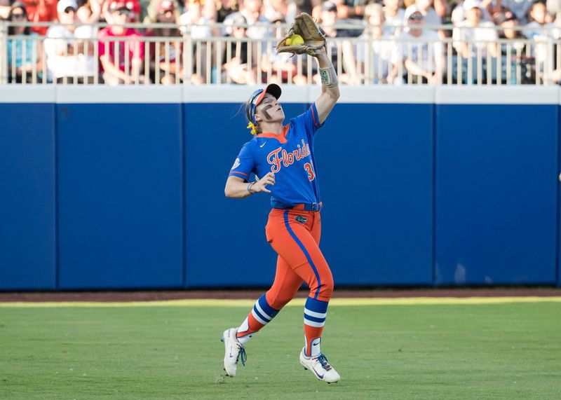 May 30, 2025; Oklahoma City, OK, USA; Florida Gators outfielder Korbe Otis (33) makes an out in the fourth inning against the Tennessee Lady Volunteers during the NCAA Softball Women's College World Series at Devon Park. Mandatory Credit: Brett Rojo-Imagn Images