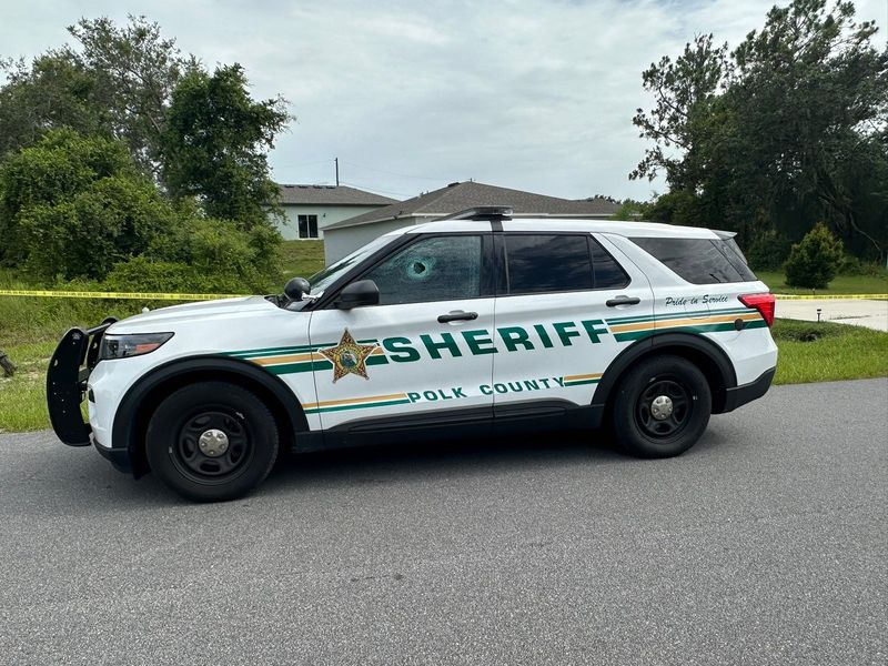 A Polk County Sheriff's Office patrol vehicle shows a bullet hole through a window from where a Poinciana man shot at the deputy on June 30.