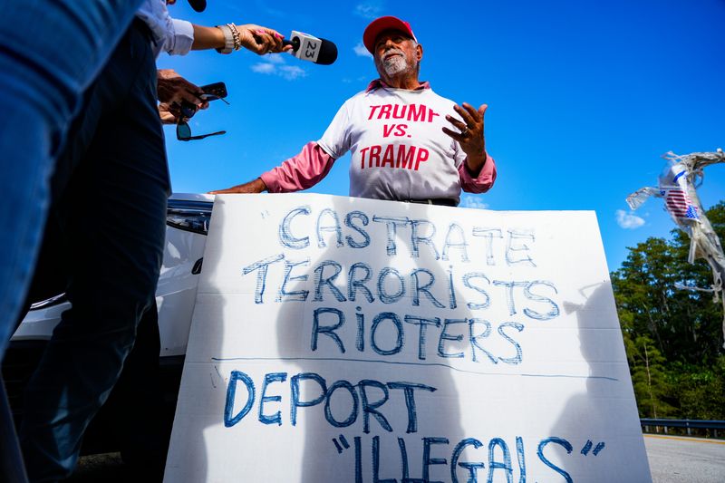 July 1, 2025; Ochopee, Florida, United States; A President Donald Trump supporter speaks with media outside of the immigration detention center known as “Alligator Alcatraz” at the Dade-Collier Training and Transition Airport on July 1, 2025. Mandatory Credit: Jonah Hinebaugh-Naples Daily News