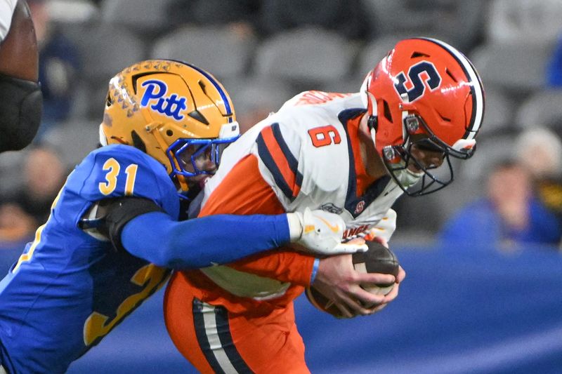 Oct 24, 2024; Pittsburgh, Pennsylvania, USA; Pittsburgh Panthers linebacker Rasheem Biles (31) sacks Syracuse Orange quarterback Kyle McCord (6) during the third quarter at Acrisure Stadium. Mandatory Credit: Barry Reeger-Imagn Images