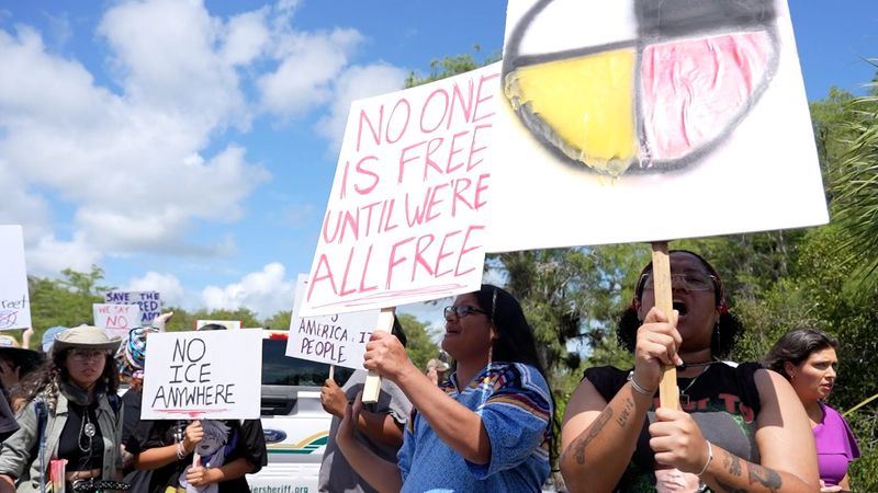 President Donald Trump toured the new Florida migrant holding facility aka "Alligator Alcatraz" as hundreds of protesters lined up outside.