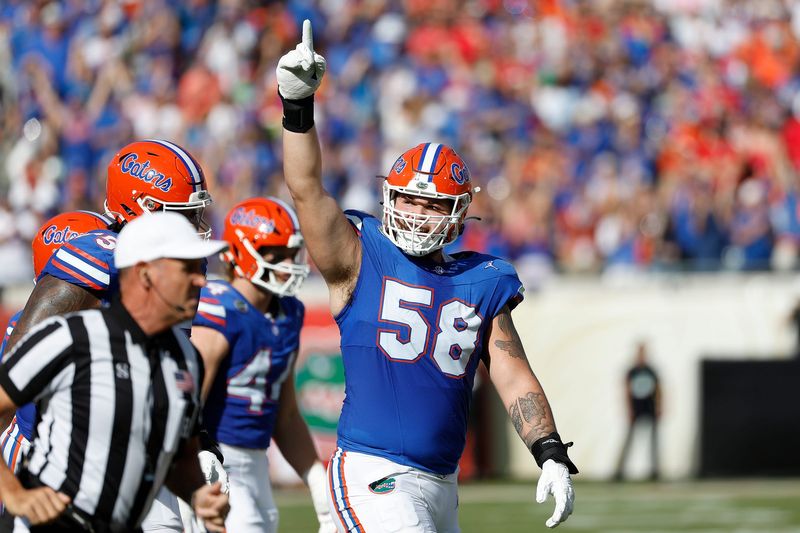 Oct 28, 2023; Jacksonville, Florida, USA; Florida Gators offensive lineman Austin Barber (58) celebrates after a first half touchdown against the Georgia Bulldogs at EverBank Stadium. Mandatory Credit: Jeff Swinger-USA TODAY Sports