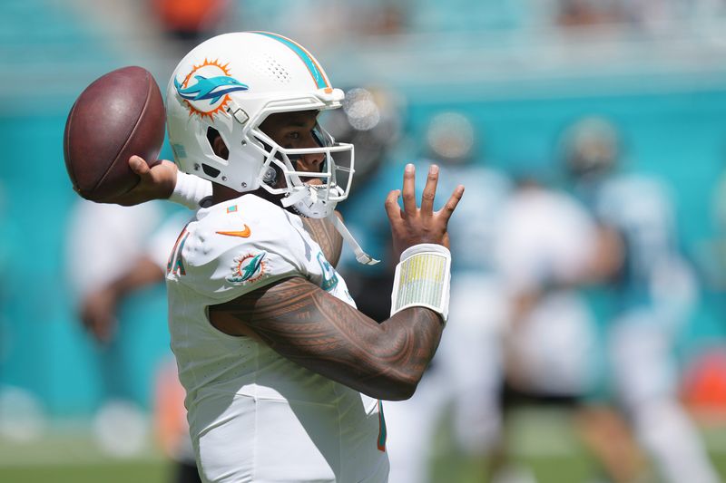 Sep 8, 2024; Miami Gardens, Florida, USA; Miami Dolphins quarterback Tua Tagovailoa (1) warms-up before the game against the Jacksonville Jaguars at Hard Rock Stadium. Mandatory Credit: Jim Rassol-Imagn Images