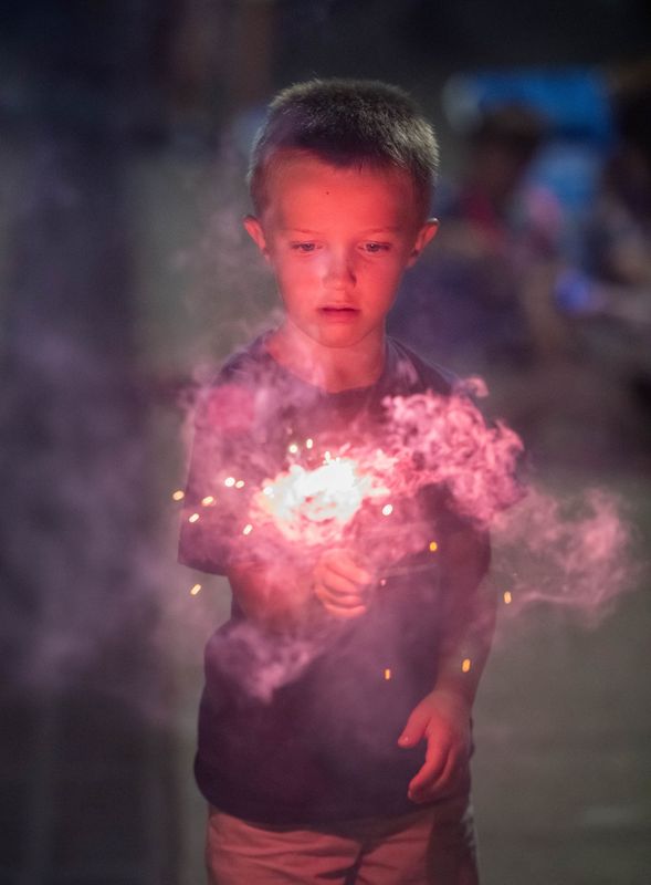 Children light sparklers as they wait for the fireworks to start at Community Maritime Park in downtown Pensacola on July 4, 2025.