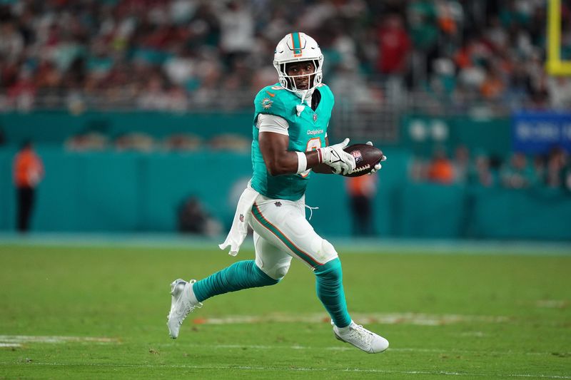Dec 22, 2024; Miami Gardens, Florida, USA; Miami Dolphins tight end Jonnu Smith (9) runs the ball after a catch against the San Francisco 49ers during second half at Hard Rock Stadium. Mandatory Credit: Jasen Vinlove-Imagn Images