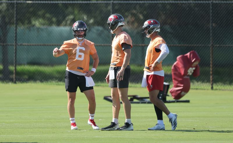 Jun 11, 2025; Tampa, FL, USA; Tampa Bay Buccaneers quarterback Baker Mayfield (6), quarterback Kyle Trask (2) and quarterback Connor Bazelak (8) talk as they work out at One Buc Place. Mandatory Credit: Kim Klement Neitzel-Imagn Images