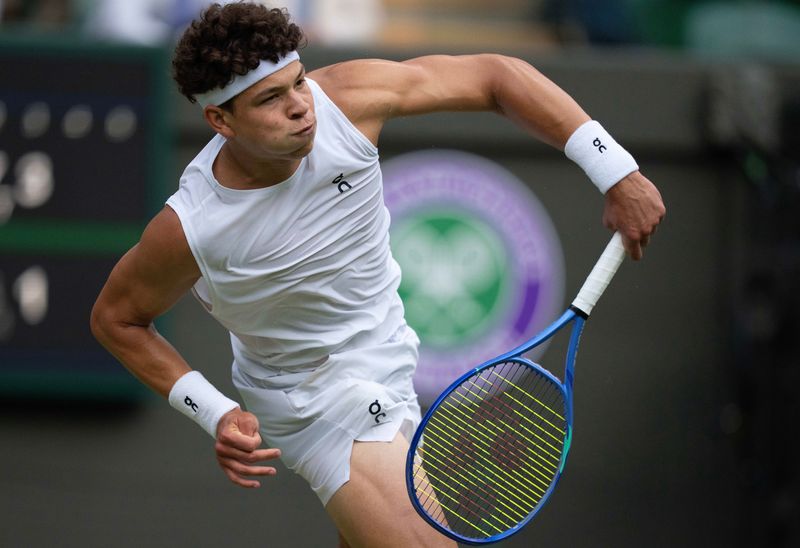 Jul 5, 2025; Wimbledon, United Kingdom; Ben Shelton of the United States serves during his match against Marton Fucsovics of Hungary on day six at the All England Lawn Tennis and Croquet Club. Mandatory Credit: Susan Mullane-Imagn Images