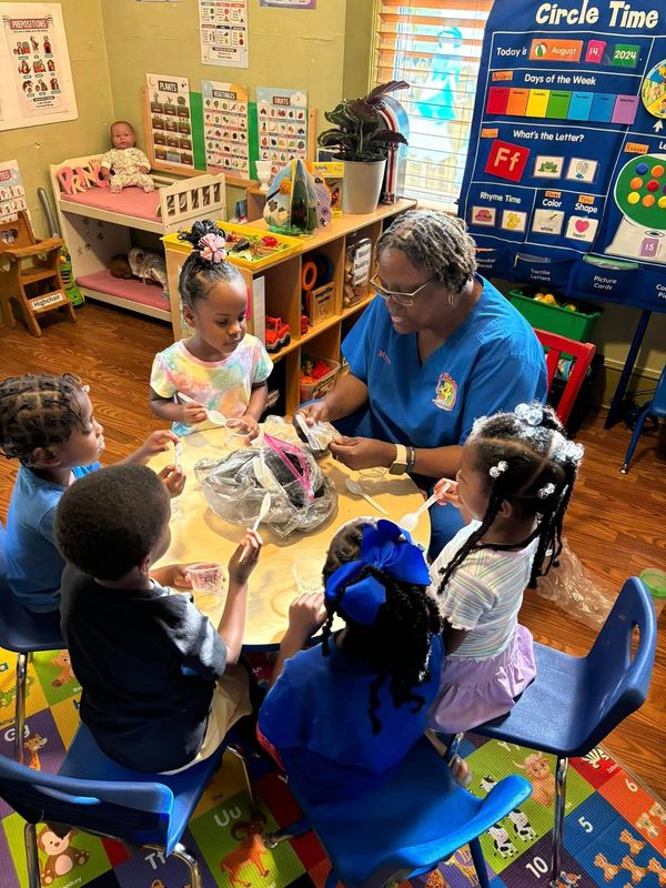 Owner-operator Myrna Wright interacts with children at J'Bear Learning Center in Jacksonville, one of 22 sites across the country selected for the WeVision EarlyEd Solutions Lab, which is studying what makes the "ideal" child care program.