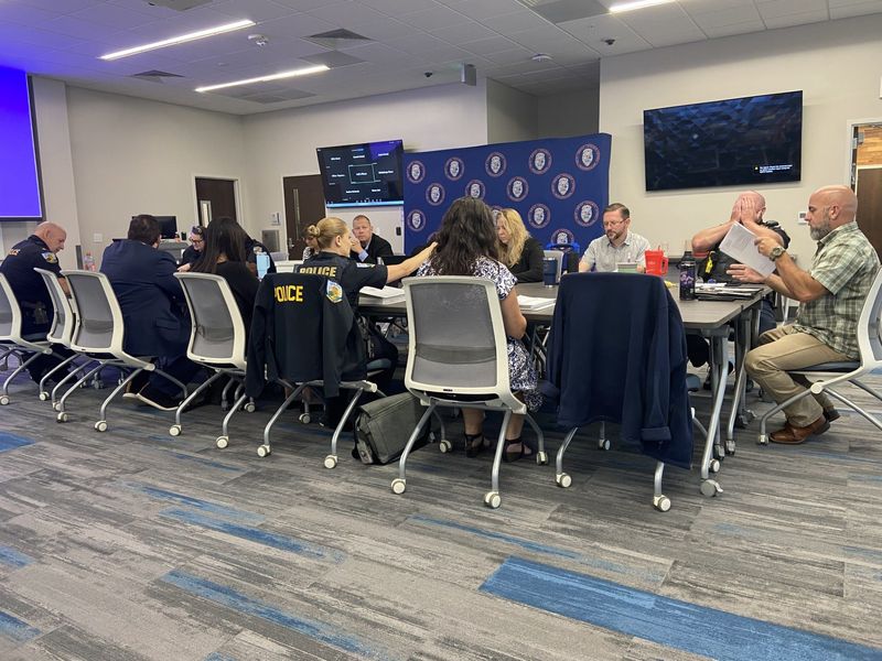 UF's chief labor negotiator, Patrick Keegan, second chair from left, sits across from the PBA's George Corwine alongside several UPD officers and attorneys during salary negotiations on July 7 on the UF campus.