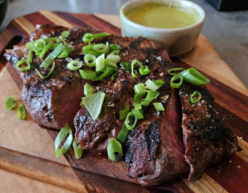The McCoy Ranch grass-fed New York strip — finished with an ancho and chile lime rub, chimichurri, and green onion — is a standout at the new Latin American restaurant Comida, located on State Street in downtown Sarasota. Photo taken June 12, 2025.