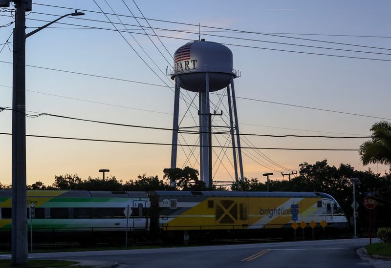 A southbound Brightline train travels past the Stuart Water Tower on Thursday, July 10, 2025.