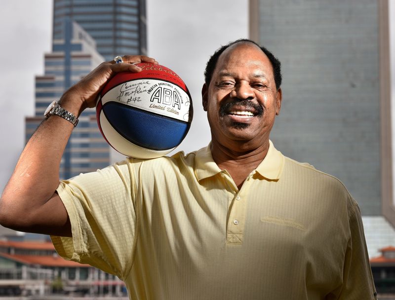 Artis Gilmore, seen here holding a ball from his days in the American Basketball Association (ABA), had a fabulous basketball career that began flourishing at Jacksonville University, where his recently deceased coach, Joe Williams, was instrumental in his development.