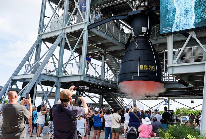 Visitors to Kennedy Space Center, Florida take a look at a simulated static test fire of a J-2 rocket engine at The Gantry at LC-39, a new exhibit at the Kennedy Space Center Visitor Complex July 10, 2025. Craig Bailey/FLORIDA TODAY via USA TODAY NETWORK