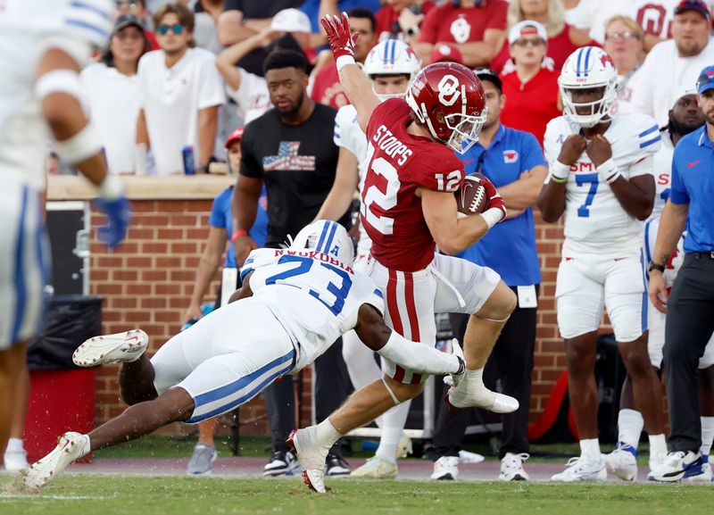 Oklahoma's Drake Stoops (12) runs after a reception as SMU's Isaiah Nwokobia (23) defends in the second half of the college football game between the University of Oklahoma Sooners and the Southern Methodist University Mustangs at the Gaylord Family Oklahoma Memorial Stadium in Norman, Okla., Saturday, Sept. 9, 2023.