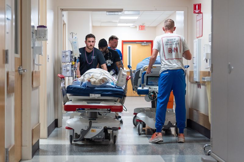 Jacob Stavres, a nurse at Tallahassee Memorial HealthCare, pushes a patient down the hallway of the emergency room Monday, May 26, 2025.