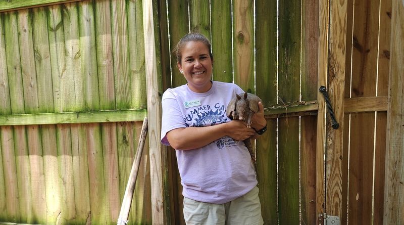 Allison Ashcroft, with a friendly smile, holding 'Chip'