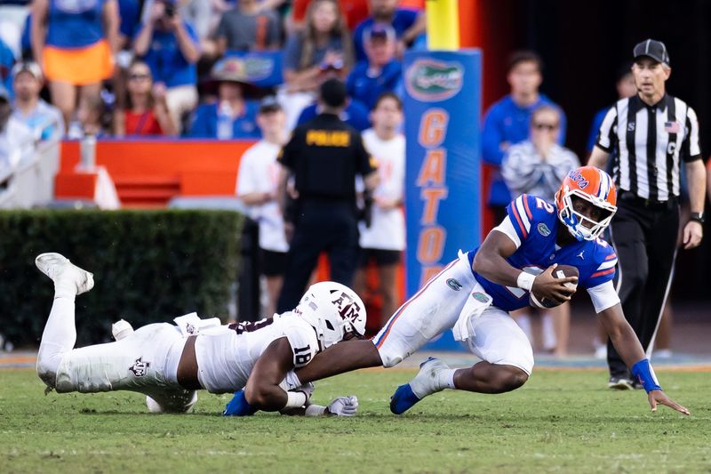Sep 14, 2024; Gainesville, Florida, USA; Texas A&M Aggies defensive lineman Cashius Howell (18) tackles Florida Gators quarterback DJ Lagway (2) during the second half at Ben Hill Griffin Stadium. Mandatory Credit: Matt Pendleton-Imagn Images