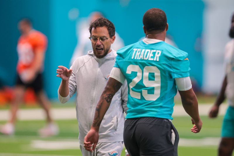 Jun 10, 2025; Miami, FL, USA; Miami Dolphins head coach Mike McDaniel talks to safety Dante Trader Jr. (29) during mandatory minicamp at Hard Rock Stadium. Mandatory Credit: Sam Navarro-Imagn Images