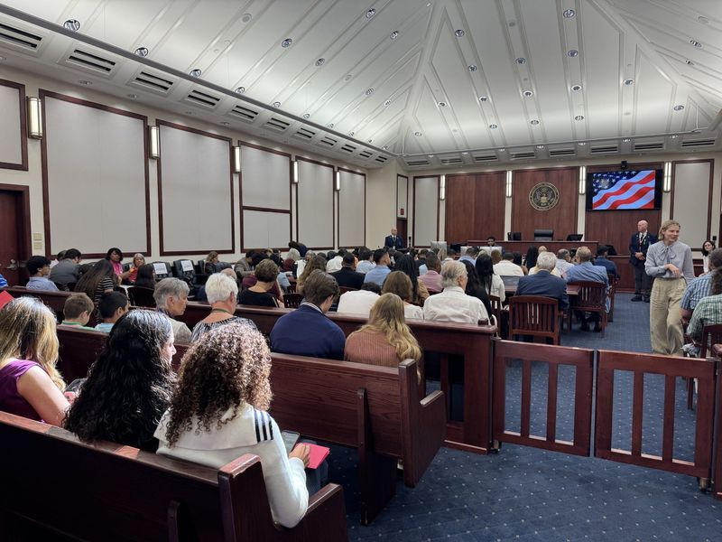 Friends and family gather in Courtroom 5 South for a naturalization ceremony featuring their loved ones.