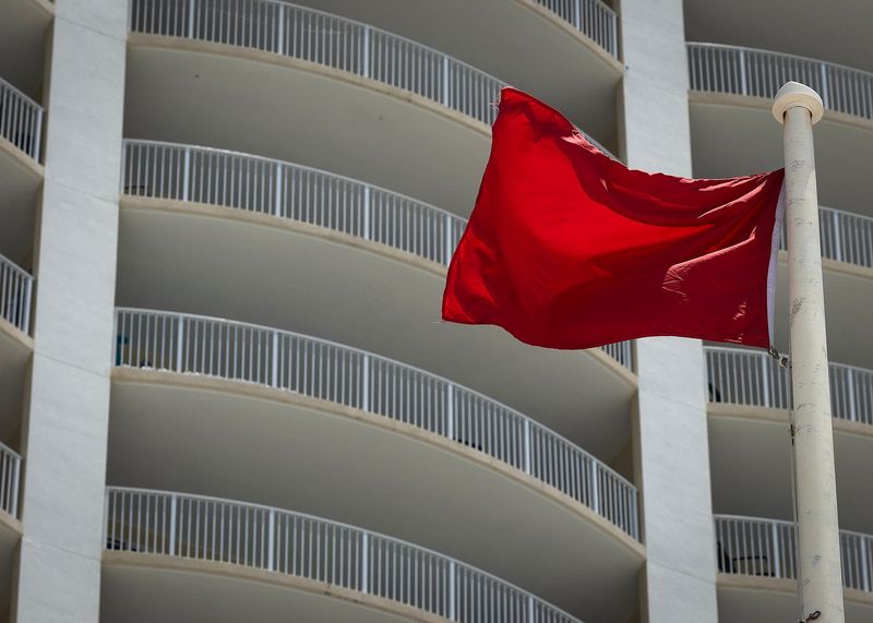A red flag is seen at Beach Access 36 in Panama City Beach, Fla., July 18, 2025. Panama City Beach officials announced the area, all the way down to Beach Access 15, will be closed from 10 p.m. to 5 a.m. between July 18-20. (Tyler Orsburn/News Herald)
