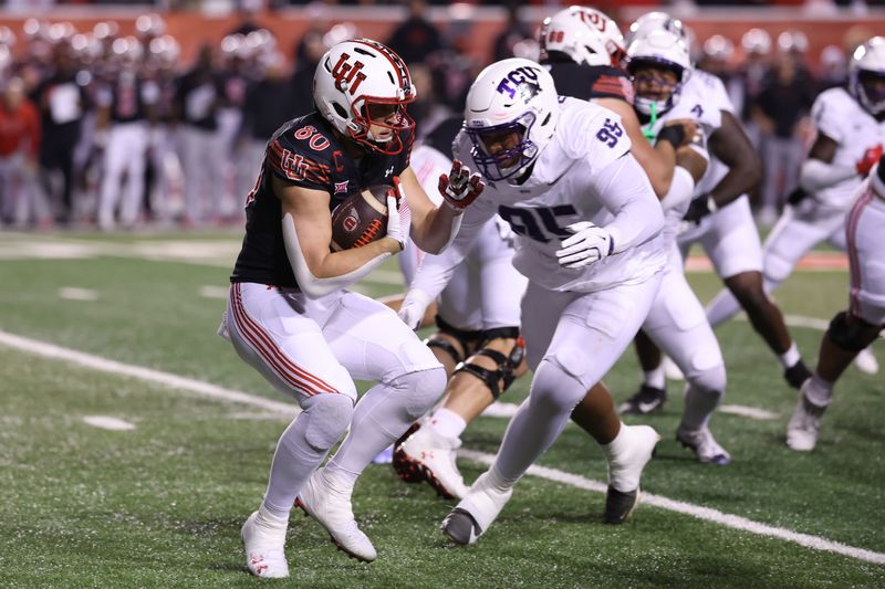 Oct 19, 2024; Salt Lake City, Utah, USA; Utah Utes tight end Brant Kuithe (80) runs against TCU Horned Frogs defensive lineman Markis Deal (95) during the first quarter at Rice-Eccles Stadium. Mandatory Credit: Rob Gray-Imagn Images