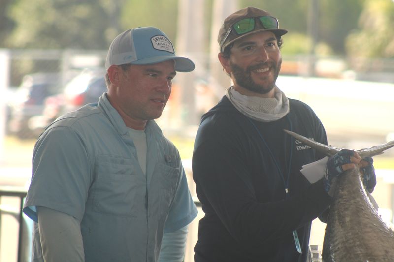 Kendall Martin and Rick Mottola, from Eric Roberts' boat Commocean, hold the winning 48.39-pound fish during the Greater Jacksonville Kingfish Tournament at Jim King Park on July 18, 2025. [Clayton Freeman/Florida Times-Union]
