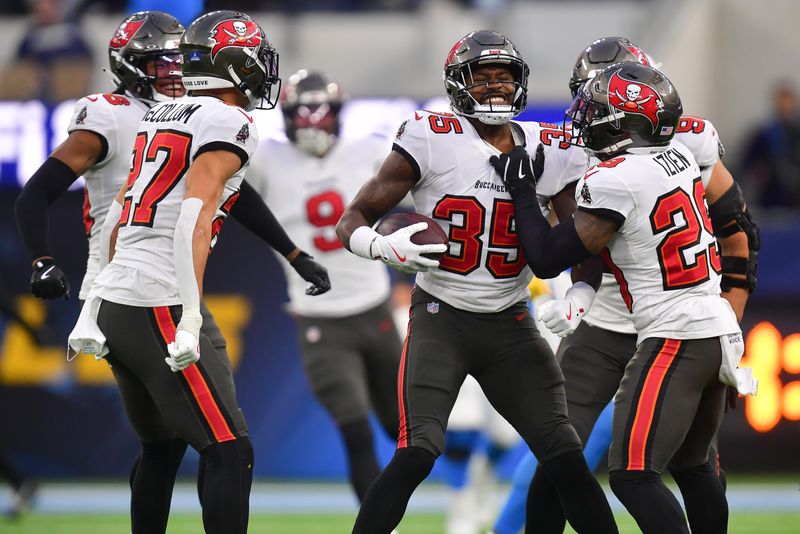 Dec 15, 2024; Inglewood, California, USA; Tampa Bay Buccaneers celebrate the interception by cornerback Jamel Dean (35) against the Los Angeles Chargers during the second half at SoFi Stadium. Mandatory Credit: Gary A. Vasquez-Imagn Images