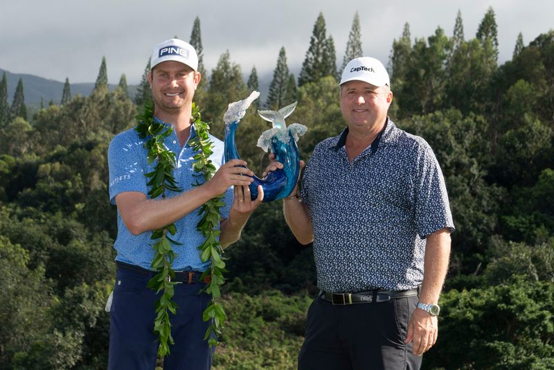 January 10, 2021; Maui, Hawaii, USA; Harris English (left) hoists the trophy with caddie Eric Larson (right) during the final round of the Sentry Tournament of Champions golf tournament at Kapalua Resort - The Plantation Course. Mandatory Credit: Kyle Terada-USA TODAY Sports