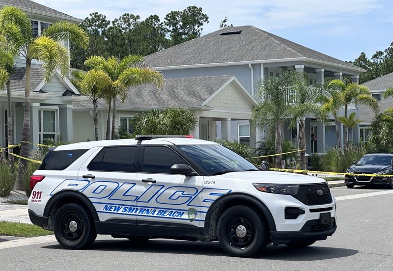 A New Smyrna Beach police cruiser secures a scene near the intersection of Meleto and Venetian Palms boulevards on July 22, 2025. Police were investigating the killing of a South Daytona man and the possible suicide of a New Smyrna Beach woman.