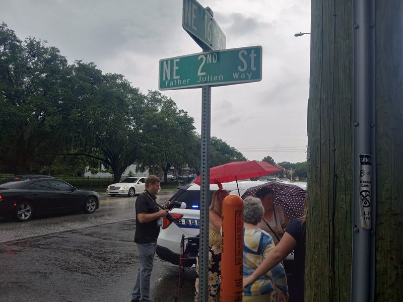 A street sign in honor of the late Father Roland Julien was unveiled July 22 at the intersection of Northeast 16th Avenue and Second Street near Saint Patrick Catholic Church in Gainesville.