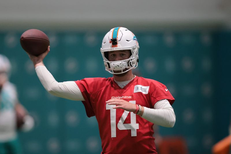 Jul 23, 2025; Miami Gardens, FL, USA; Miami Dolphins quarterback Quinn Ewers (14) throws the football during training camp at Baptist Health Training Complex. Mandatory Credit: Sam Navarro-Imagn Images