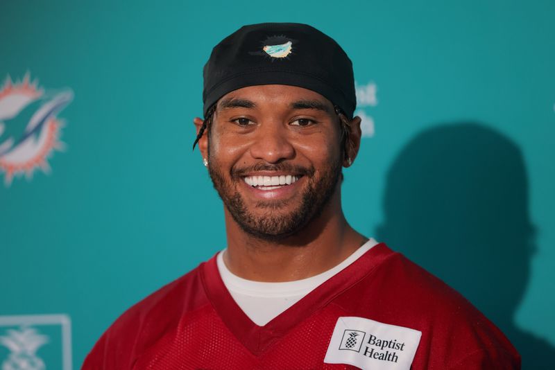 Jul 23, 2025; Miami Gardens, FL, USA; Miami Dolphins quarterback Tua Tagovailoa (1) speaks to reporters during training camp at Baptist Health Training Complex. Mandatory Credit: Sam Navarro-Imagn Images