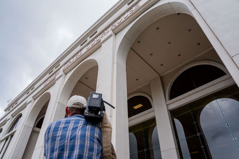 Phil Willitte, cameraman for Spectrum News, gets B-roll while waiting for the deposition of Ghislaine Maxwell to be completed at the Federal Courthouse in Tallahassee, Florida on Thursday, July 24, 2025.