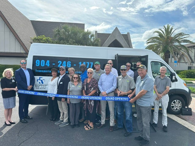Baptist Health and Beaches Council on Aging representatives celebrate the council's new wheel-chair accessible van, which was funded by a Baptist donation.