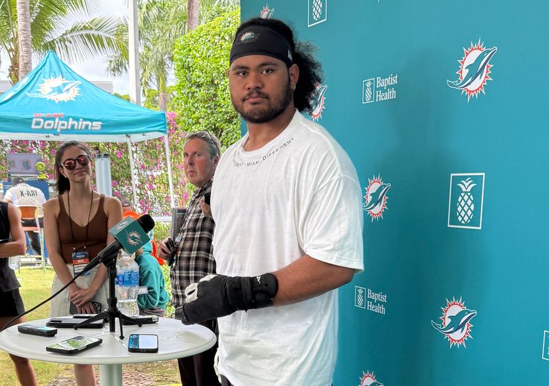 Miami Dolphins rookie Jonah Savaiinaea meets with reporters at training camp