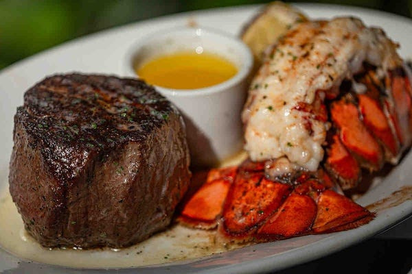 An 11-ounce filet served with lobster tail and drawn butter at Ruth's Chris Steak House at Harbourside Place in Jupiter, Fla.